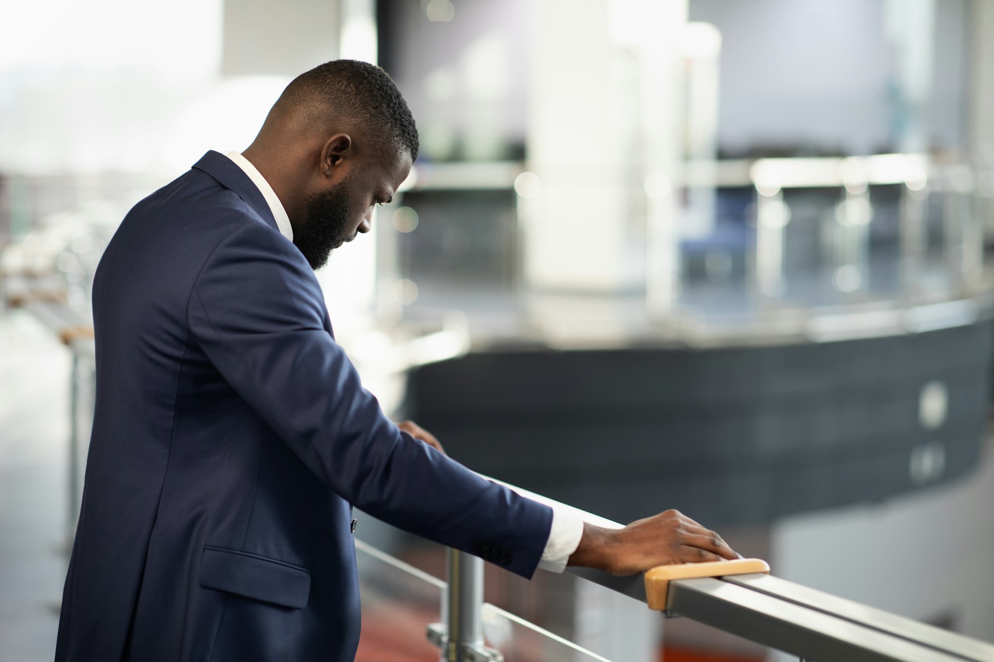 Stressed african american entrepreneur standing by railing